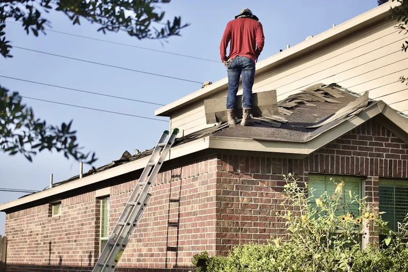 Professional roofer working on a residential roof in Hunters Crossing